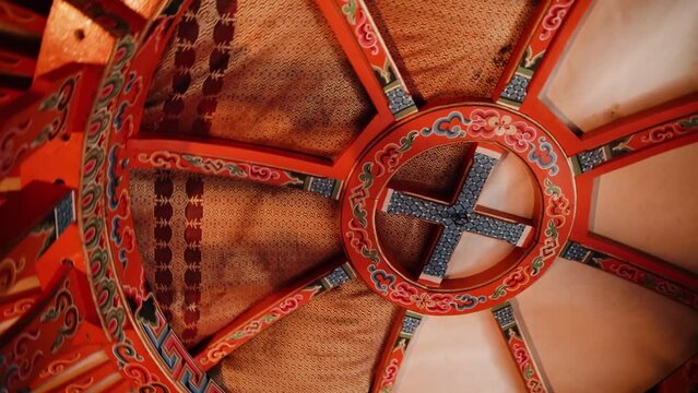Inside a real Mongolian tent. Traditional mongolian yurt interior. Mongolia decorating ceiling with decor furnishing objects equipment style elements house domestic