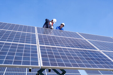 Maintenance engineer at solar farm stand on scissor lift inspection solar panel and repair