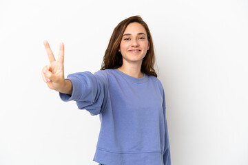 Young caucasian woman isolated on white background smiling and showing victory sign