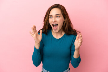 Fototapeta premium Young caucasian woman isolated on pink background with surprise facial expression