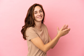 Young caucasian woman isolated on pink background applauding