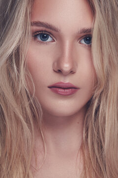 Young woman with blonde hair, blue eyes, natural make up, clear skin models for a beauty photoshoot