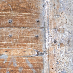 Italy, Perugia, summer 2022. Fragment of an Italian wooden door with metal inserts