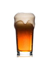 Pint of ale with overflowing foam on white background.