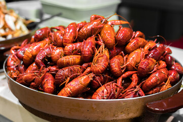 A heap of spicy boiled crawfish in a serving tray.