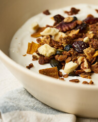 Greek yogurt with granola, dried fruit, and honey drizzle.