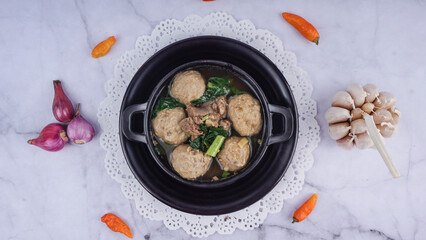 Top View - Indonesian Famous Foodstreet Bakso or Meatballs in a wok over marble texture background