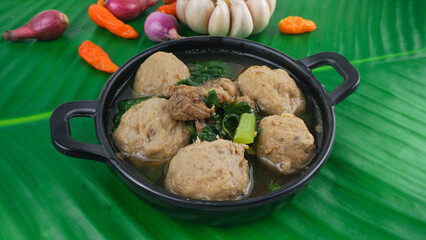Bakso or Meatball in wok pan over banana leaf. Popular Indonesian street food