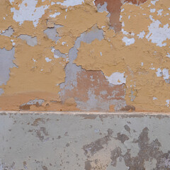 Italy, Perugia, summer 2022. Fragment of an orange-gray wall with crumbled plaster