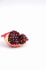 Fresh pomegranate photographed against a white background. Source of vinamines. Fresh fruit