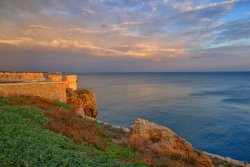 Fototapeta na wymiar Sunrise colours over Polignano a Mare resort in Puglia, Italy, Europe 