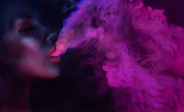 Art Portrait of Beautiful Woman with glamorous mystical makeup blowing fuchsia smoke