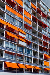 Facade of Block of Flats apartment house in Rotterdam Netherlands with Balconys, windows and orange...
