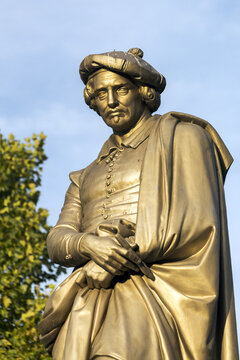 Bronze statue of Rembrandt with trees and blue sky in the background; Amsterdam, Netherlands