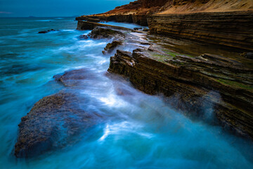 San Diego Seascape Series, turquoise-colored seawater and white silky seafoam splashing to the cliff at Sunset Cliffs in Cabrillo National Monument, Southern California, USA, long exposure photography