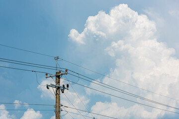 Obraz premium View of Telephone poles with blue sky and white clouds as a background
