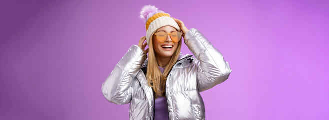 Carefree amused charming blond girlfriend having fun enjoying awesome sunny winter day ski resort...