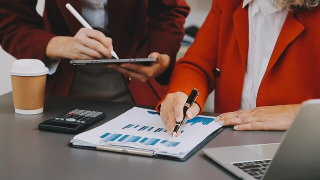 Businessman and team analyzing financial statement Finance task. with smart phone and laptop and tablet. Wealth management concept