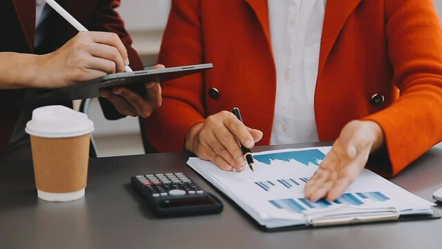 Businessman and team analyzing financial statement Finance task. with smart phone and laptop and tablet. Wealth management concept