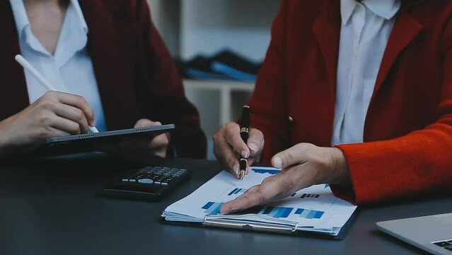 Businessman and team analyzing financial statement Finance task. with smart phone and laptop and tablet. Wealth management concept