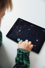 Boy is playing with a tablet