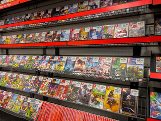 Obraz premium Seattle, WA USA - circa December 2022: Selective focus on used video games for sale inside a GameStop gaming store.