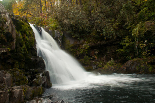 A scenic view of Abrams Falls, moss-covered boulders, and the forest in autumn.; Abrams Falls, Great Smoky Mountains National Park, Tennessee.