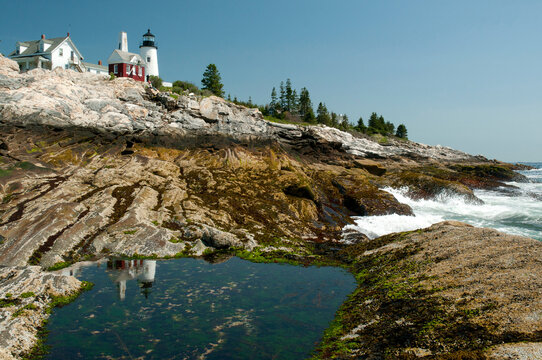 The Pemaquid lighthouse and its reflection in a coastal tidal pool.; Pemaquid Point, Maine.