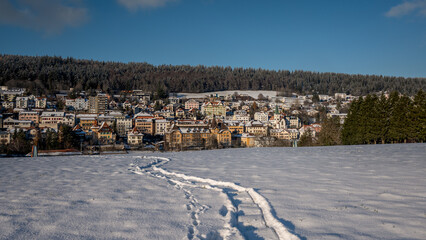 Winter landscape with snow. Tramelan village in sunny day. Bern Canton, Switzerland.