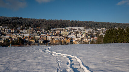 Obraz premium Winter landscape with snow. Tramelan village in sunny day. Bern Canton, Switzerland.