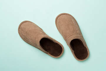 Man's slippers on color background, top view