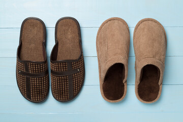 Man's slippers on wooden background, top view