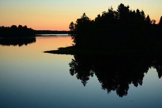 Predawn light, silhouettes, and reflections at La Source.; La Source, Kouchibouguac National Park, Kouchibouguac, New Brunswick, Canada.