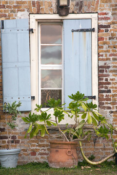 Shutters on an old house, which is now a restaurant and gift shop in Nelson's Dockyard National Park on the island of Antigua; Antigua, Antigua and Barbuda