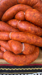 Group of chorizo piled on wooden board