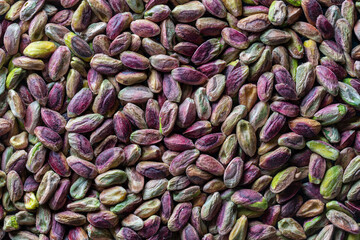 Pile pistachio kernels nuts without shell, closeup. Pistachios without shell, top view. Whole nut kernels