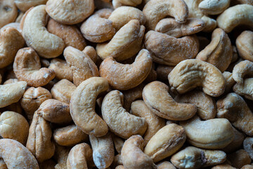 Pile cashew nuts without shell, closeup, top view. Whole nut kernels