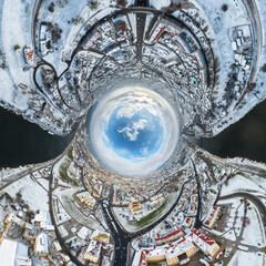 blue sphere inside overlooking winter old town, urban development, historic buildings and crossroads with cars with snow. Transformation of spherical 360 panorama in abstract aerial view.
