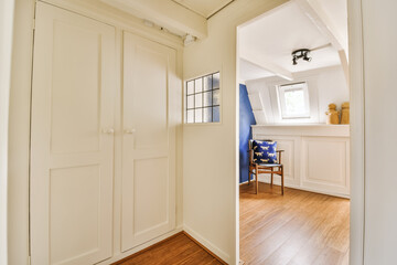 a room with wood flooring and white doors in the doorway leading to an open door that leads to...