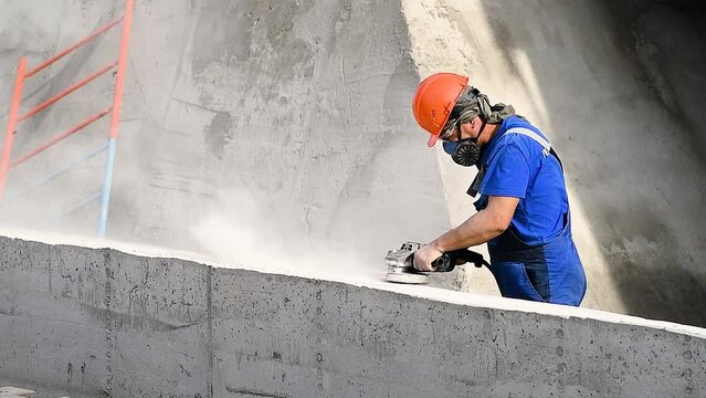 The builder works with an angle grinder