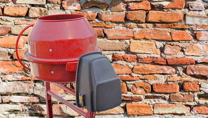 concrete mixer on the background brick wall