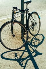 Fototapeta na wymiar Vertical shot of a nice parked bicycle outdoors in the street on a sunny day.