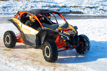 winter moto baggy racing across the river. crazy car racing © Natalia Udalova