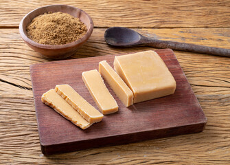 Doce de leite or dulce de leche, traditional south american milk candy over wooden board