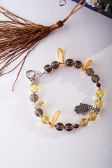 stylish jewelry bracelet with natural semiprecious , rauchtopaz and citrine. around white background. hobby and fashion concept. close up