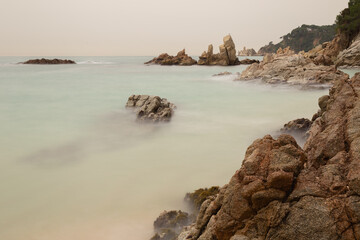 Fototapeta na wymiar Fantastic seascape with rocks and sea with silk effect.