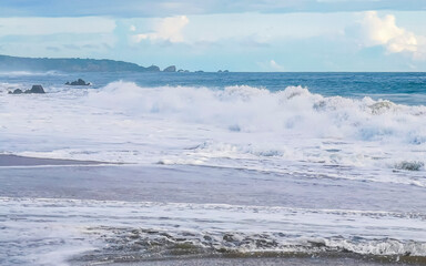 Naklejka na ściany i meble Big surfer waves snd rocks at beach Puerto Escondido Mexico.