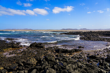 Fototapeta na wymiar Caleta del Marrajo, a windy bay on the north coast of Fuerteventura in the Canary Islands, Spain - Desertic landscape near the Atlantic Ocean