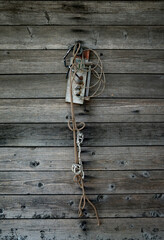 Pieces of wire, the old thermometer hanging on a wooden texture.
