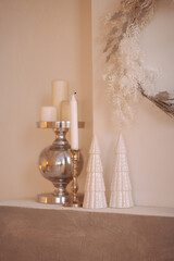 Christmas decorations on mantelpiece on white wall background